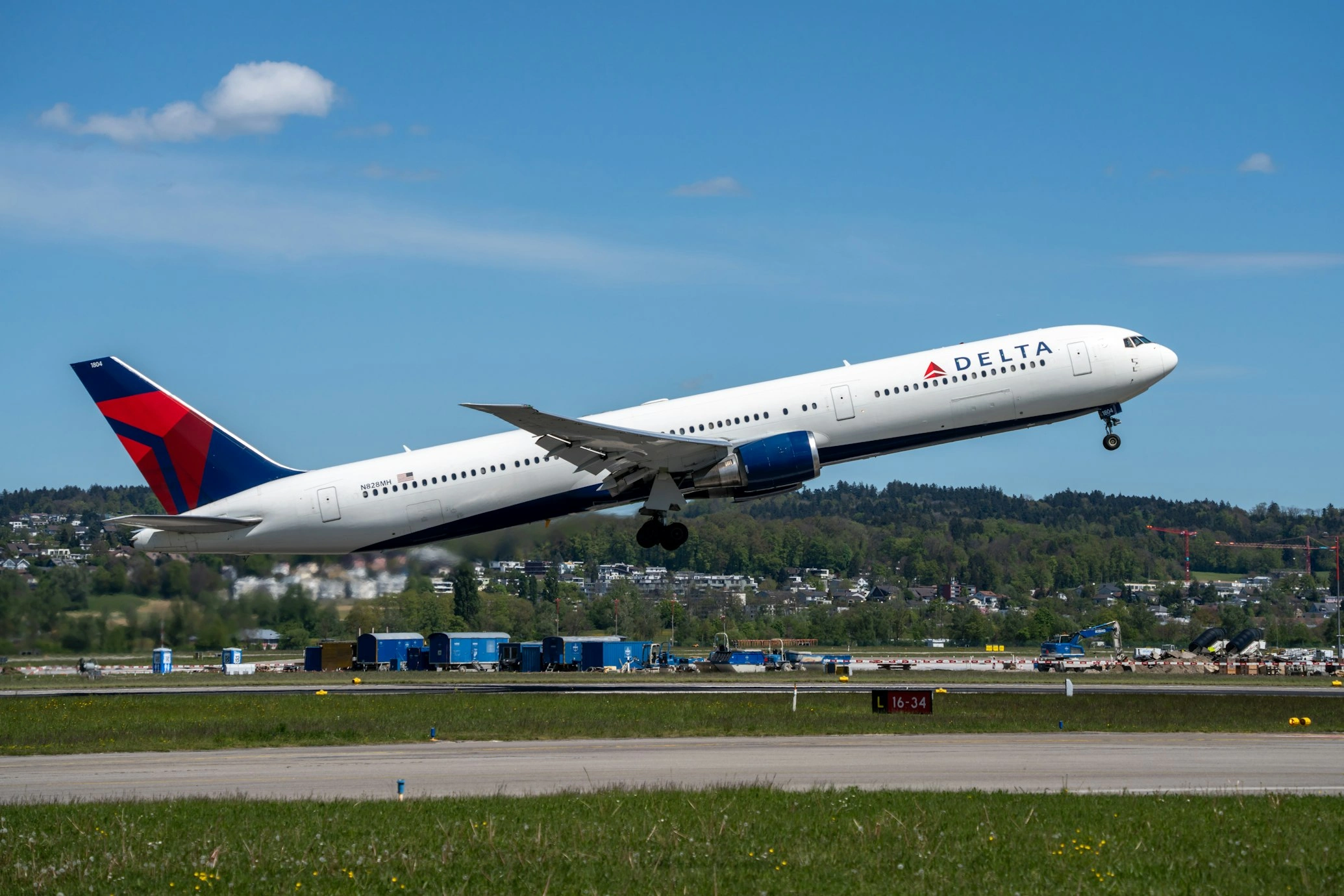 a delta boeing 767 taking off from the zurich airport