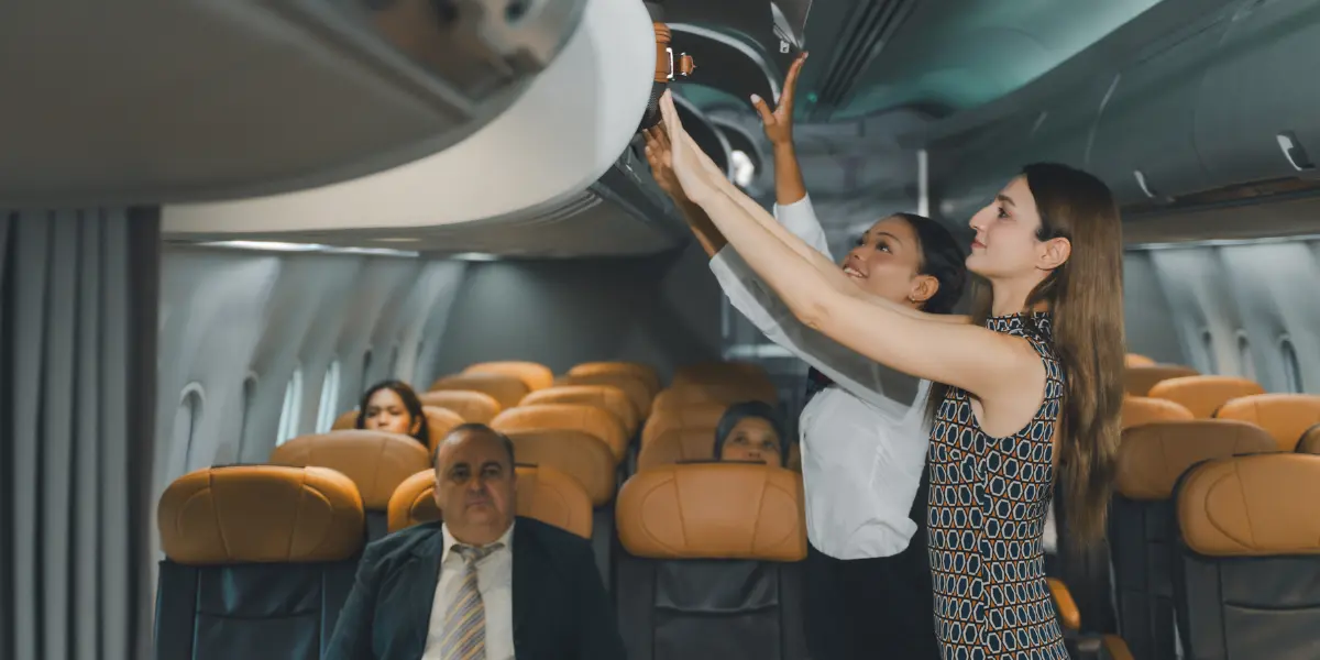 boarding group putting baggages on overhead bins