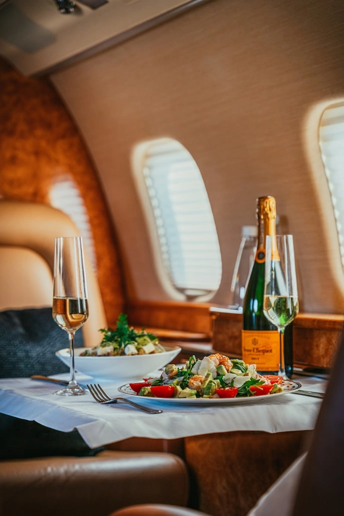 Business class meal service with tablecloth and multi-course tray settings
