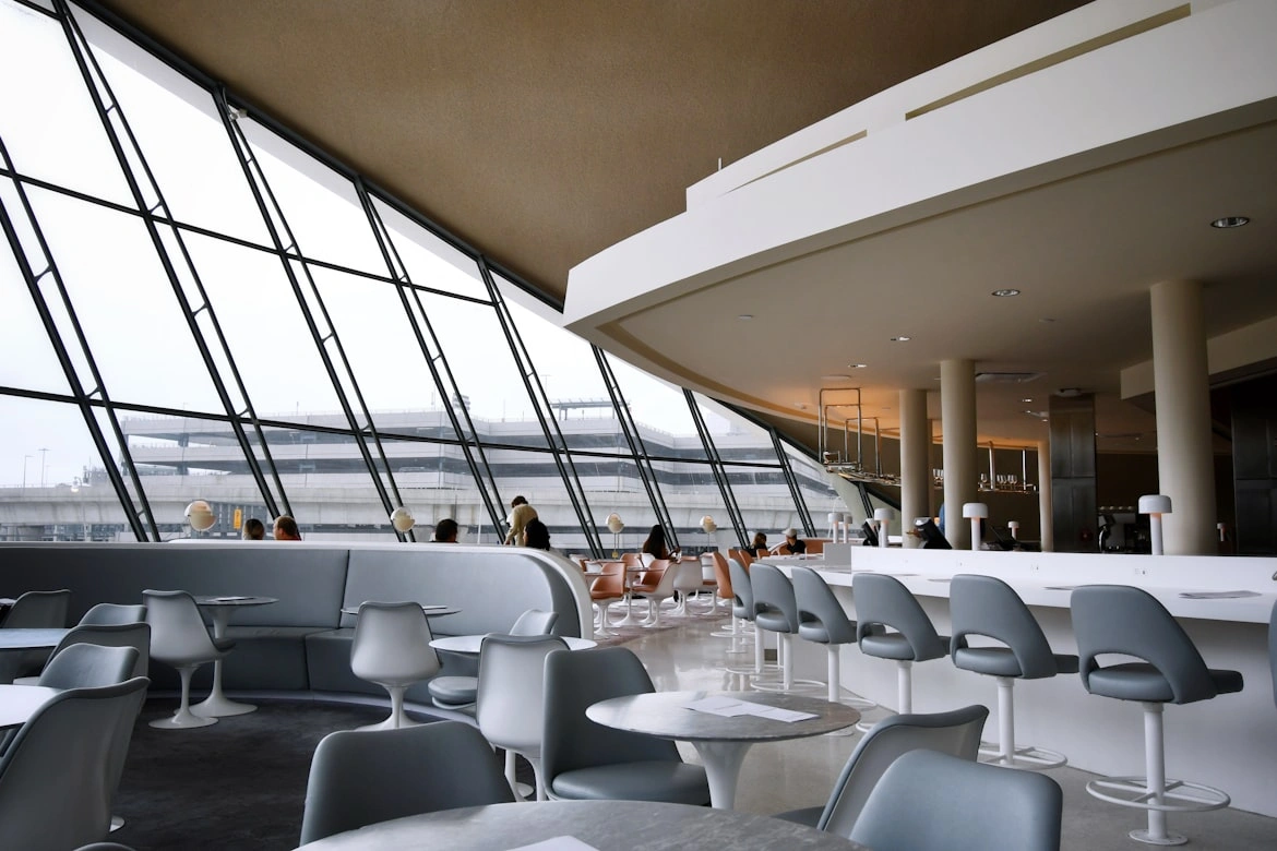 Business frequent us traveler working on a laptop in an airport lounge seating area