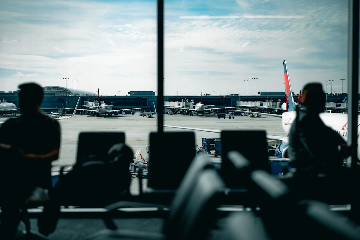 delta airlines business travelers waiting on airport terminal