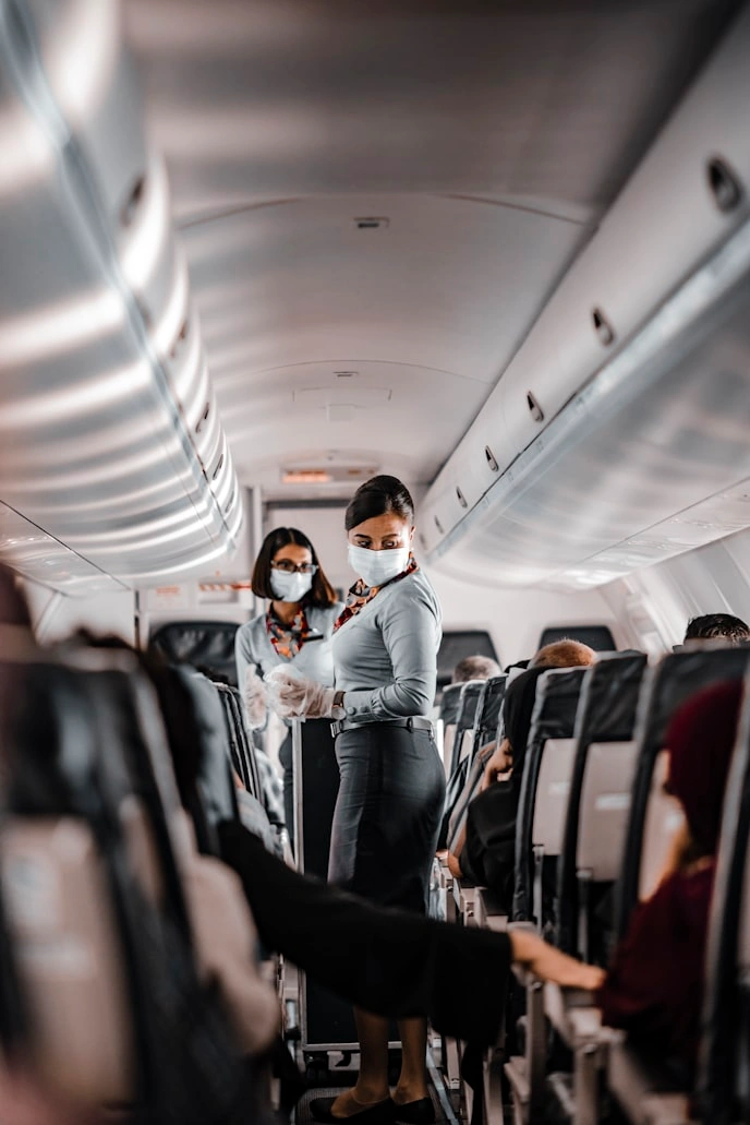 flight attendants dealing with the unruly passengers on a plane