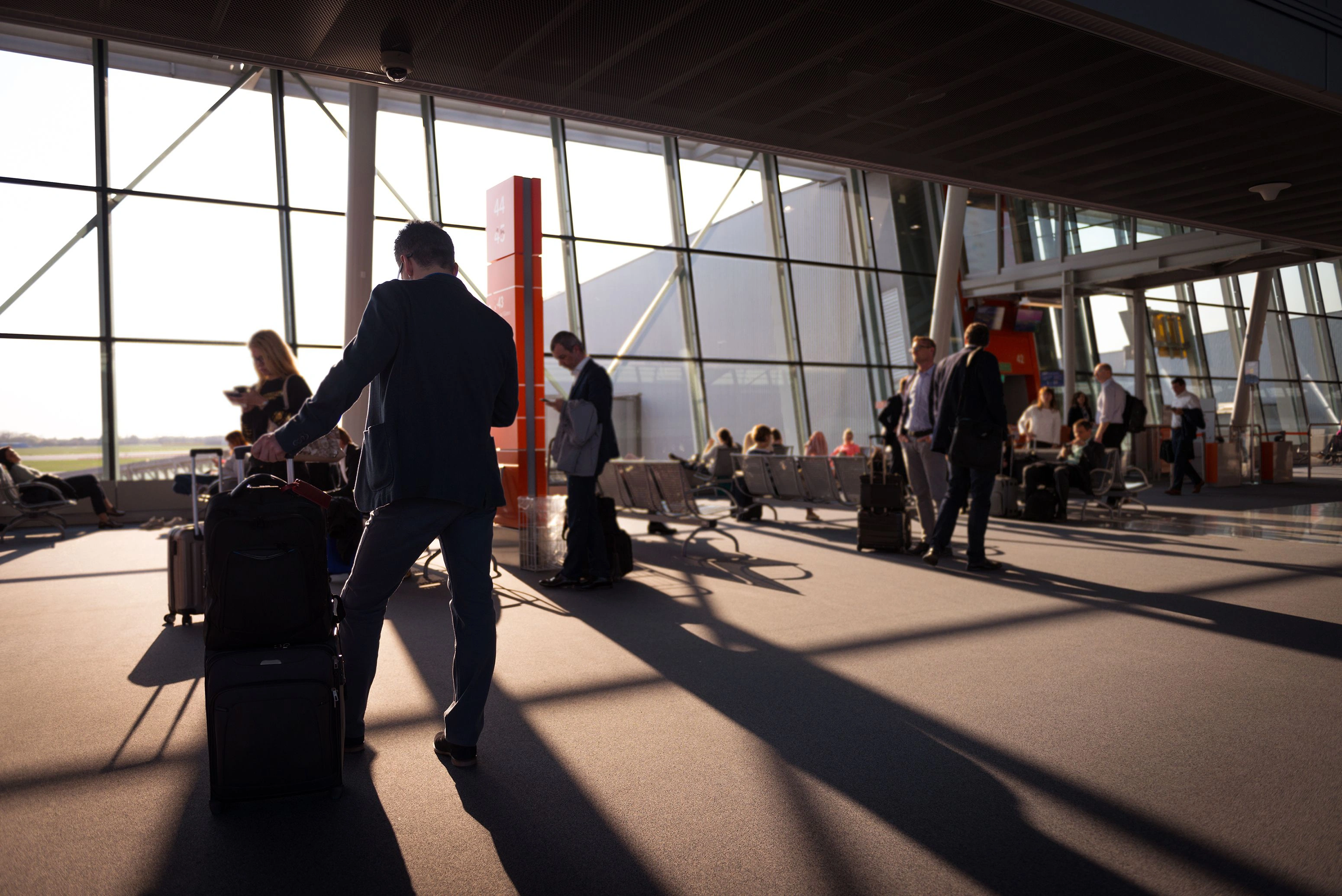 frequent business travelers waiting at newark liberty international airport terminal
