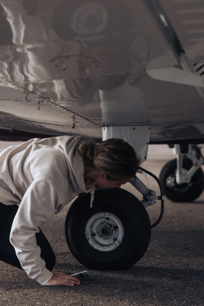 girl checking aircraft before flying as a private pilot trainee