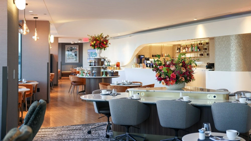 Modern delta airlines airport business lounge with lounge seating and warm lighting at terminal 2