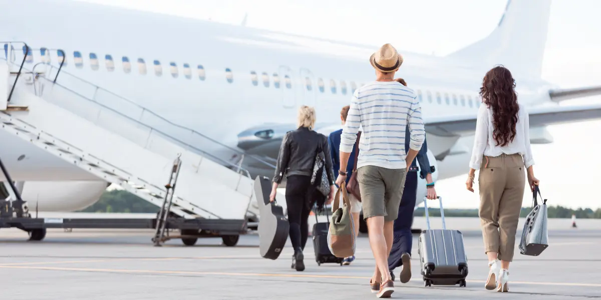 passengers with checked bags boarding on a plane