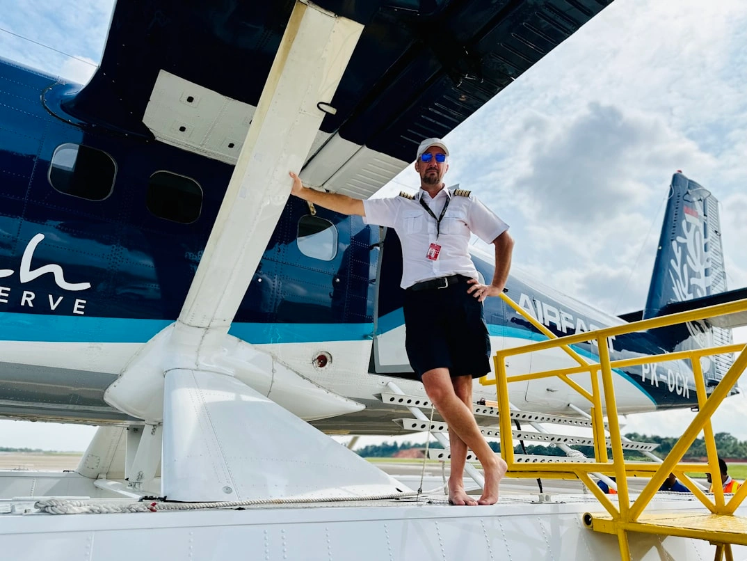 pilot flexing infront of the aircraft in his retirement days