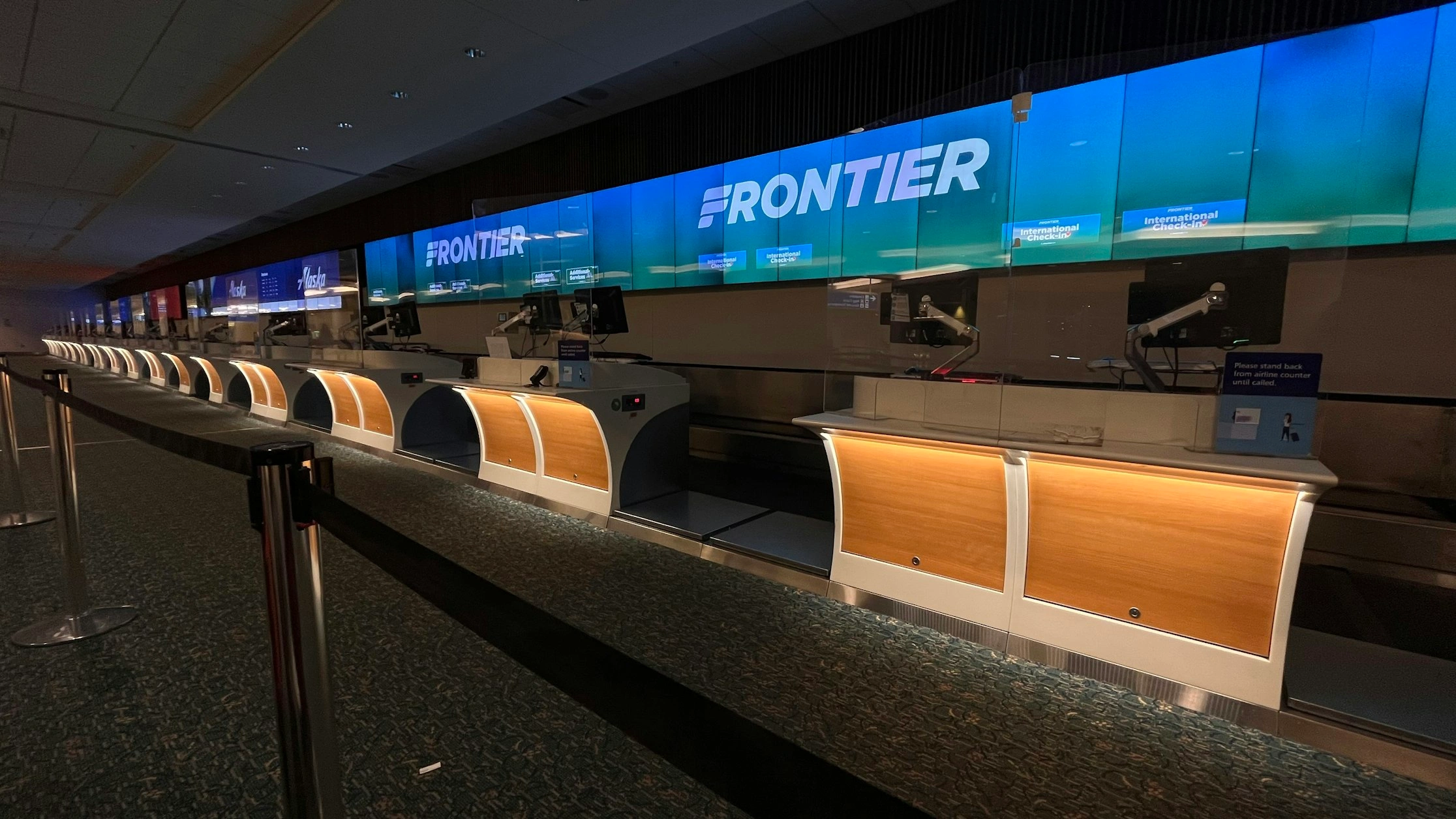 terminal of frontier airlines with table and electronics
